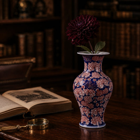 Cobalt aubergine porcelain Guanyin bottle vase styled on library desk with dahlia stem