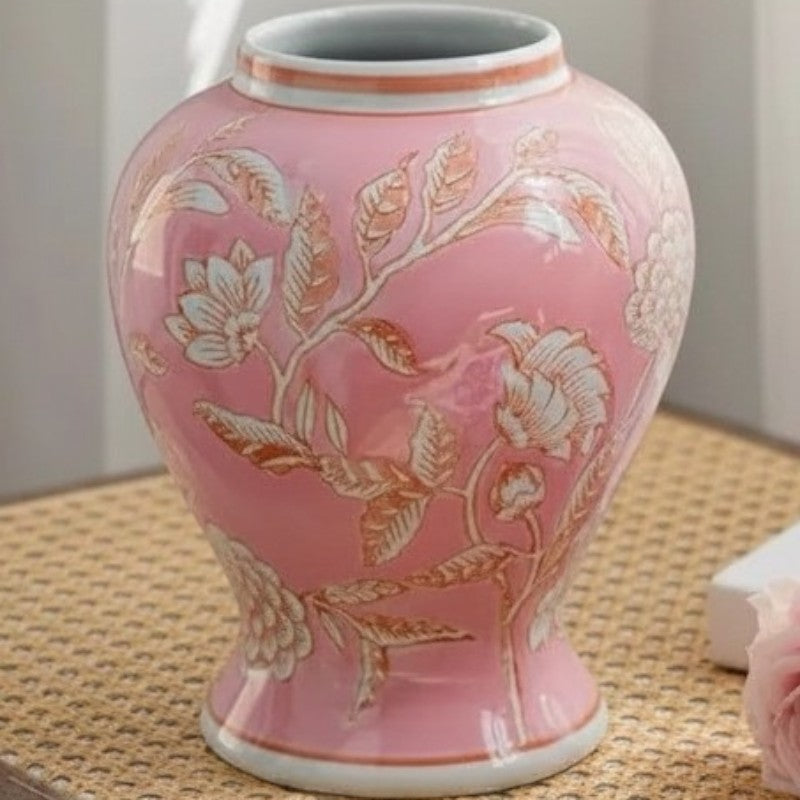 Pink pot-belly chinoiserie ceramic vase on a rattan surface — Holm & Hearth
