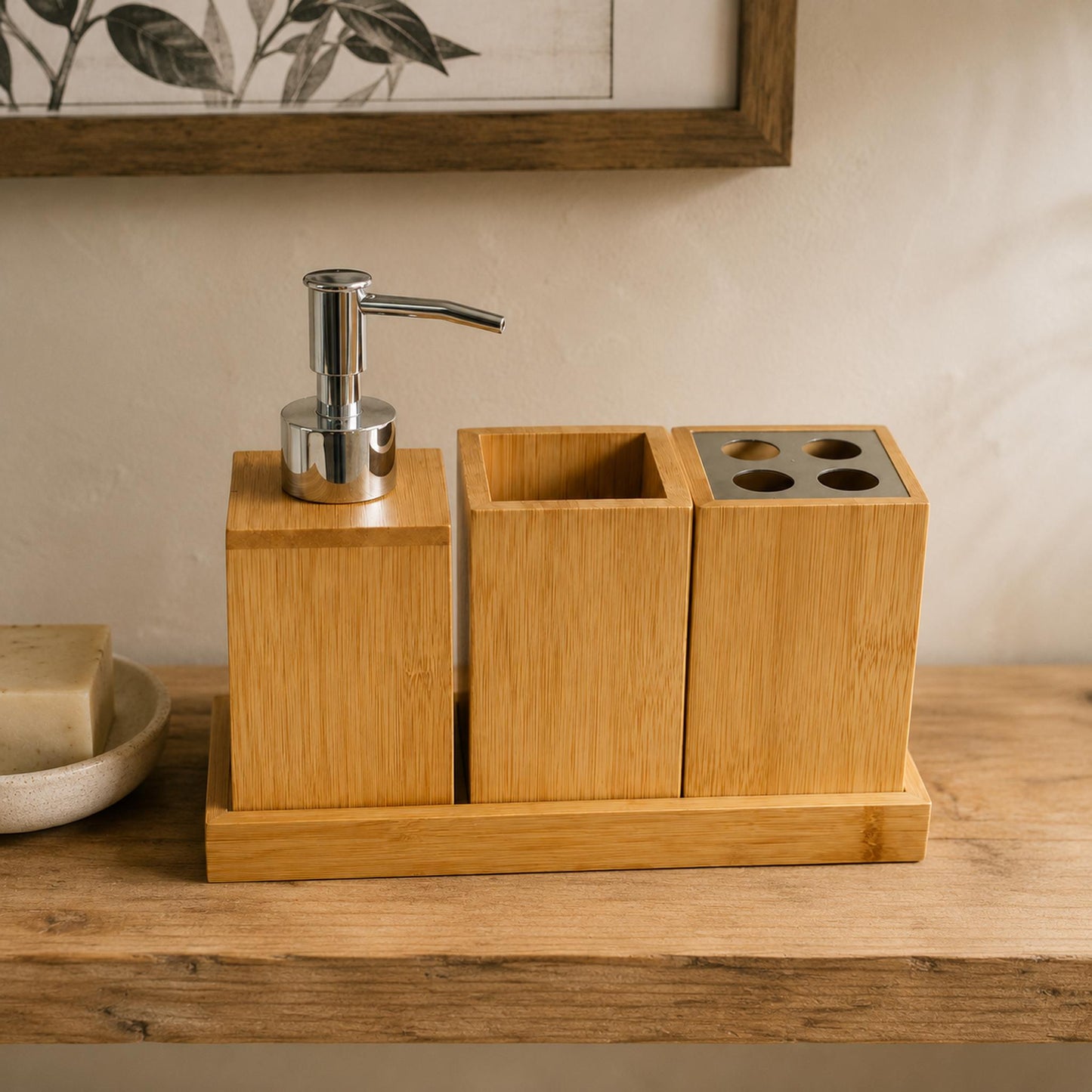 Bamboo bathroom organiser 4-piece set flat lay on warm off-white linen with dried eucalyptus, soap dispenser tumbler toothbrush holder and tray