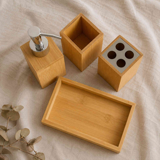Bamboo bathroom organiser 4-piece set on warm wooden vanity with framed botanical print and natural soap dish, lifestyle shot