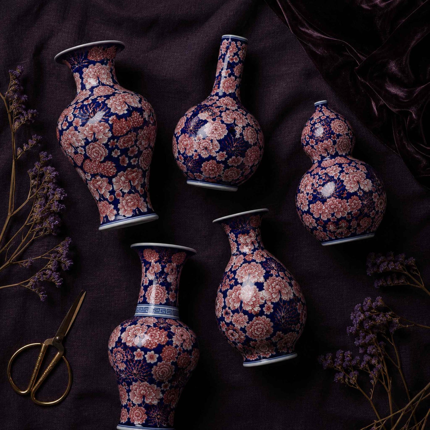 Cobalt aubergine porcelain vase flat lay of all five hand-painted shapes on dark linen