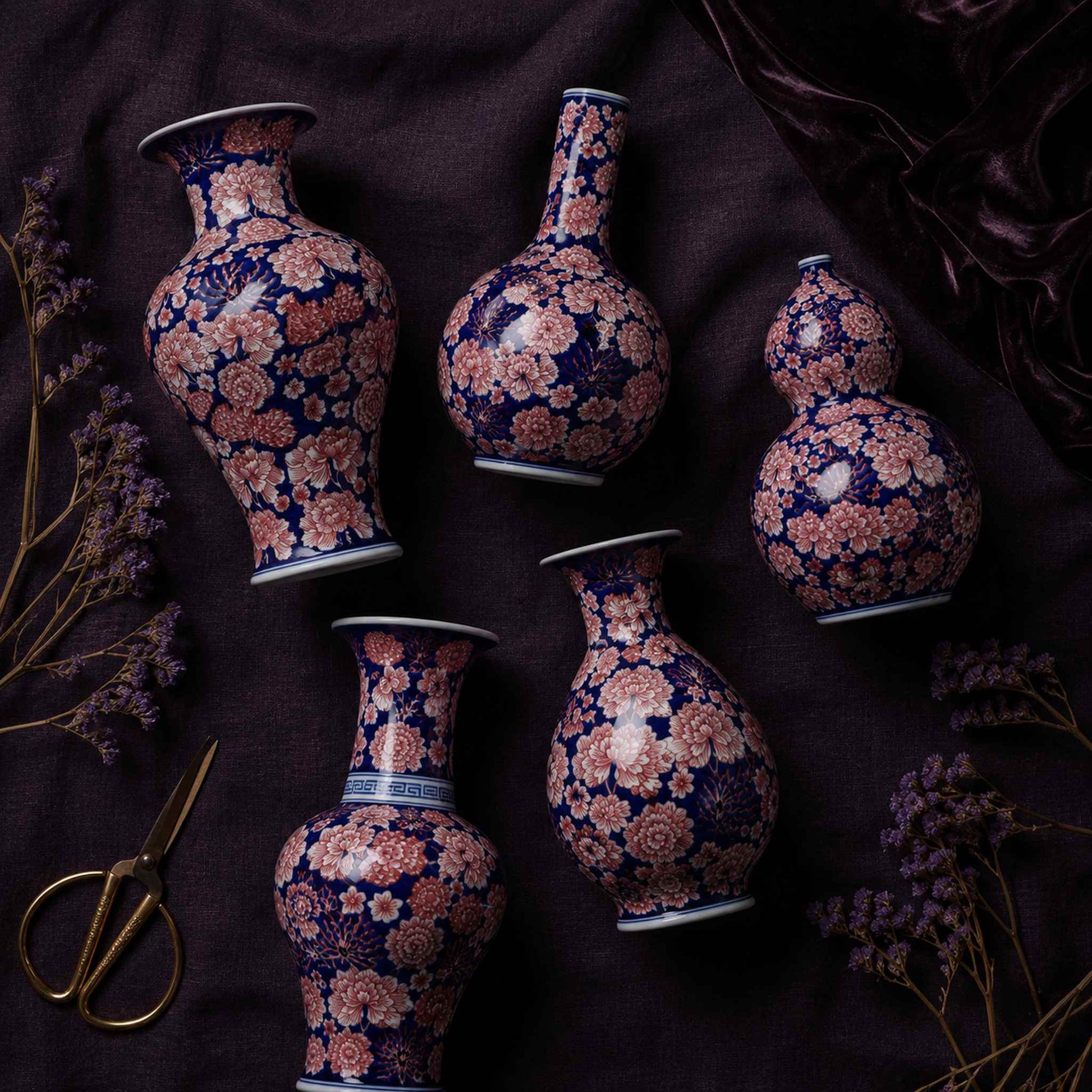 Cobalt aubergine porcelain vase flat lay of all five hand-painted shapes on dark linen