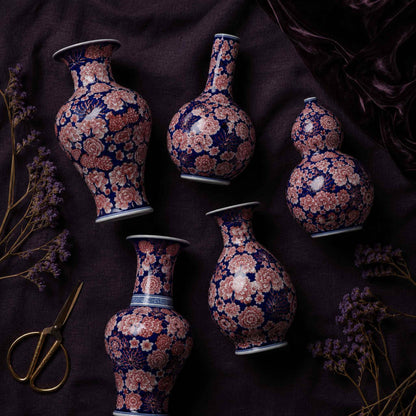 Cobalt aubergine porcelain vase flat lay of all five hand-painted shapes on dark linen