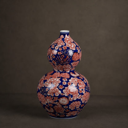 Cobalt aubergine porcelain gourd bottle vase catalogue shot on warm grey background