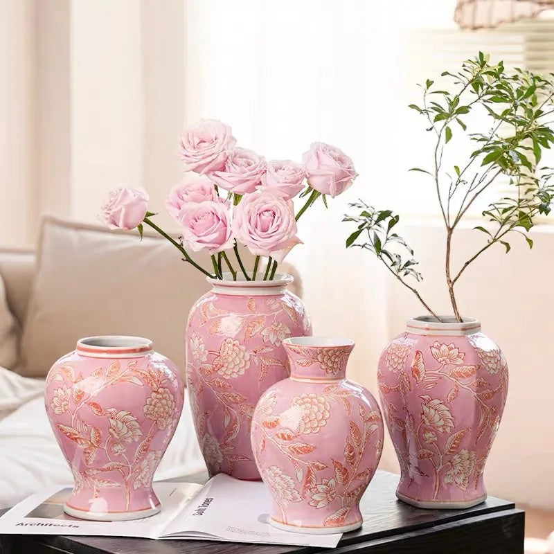 Four pink chinoiserie ceramic vases on a coffee table with roses and a branch — Holm & Hearth