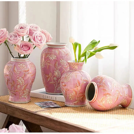 Four pink ceramic vase shapes on a woven mat with pink roses and white tulips — Holm & Hearth