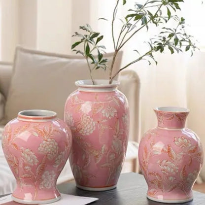 Three pink ceramic vase shapes on a dark surface beside a cosy sofa — Holm & Hearth