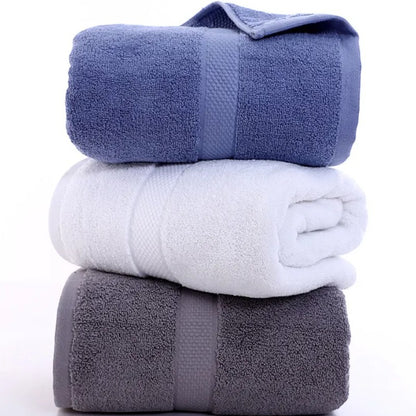 Three rolled cotton bath towels in slate, white, and cornflower — Holm & Hearth
