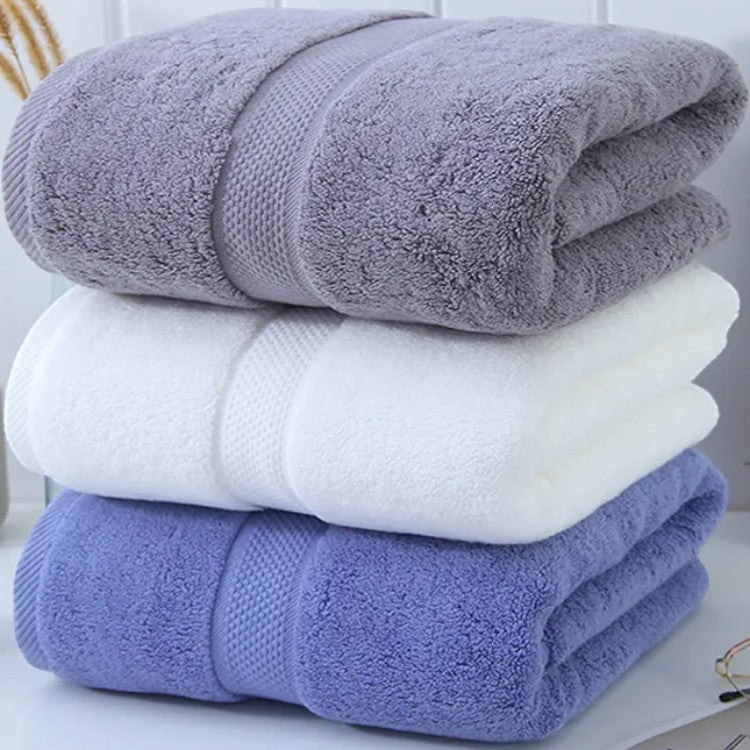 Stack of three cotton bath towels in slate, white, and cornflower with honeycomb borders — Holm & Hearth
