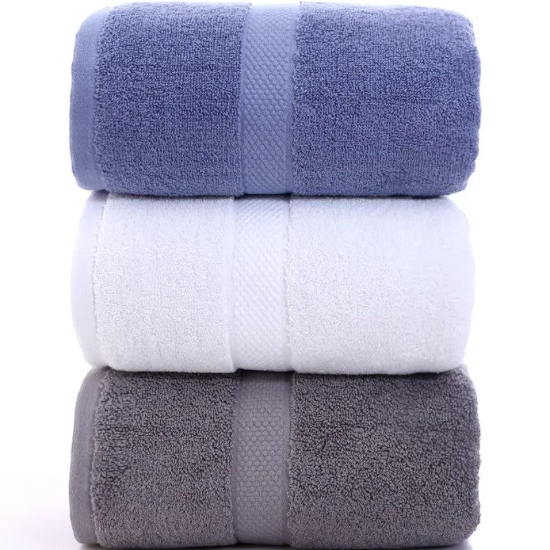 Three cotton bath towels stacked in cornflower, white, and slate — Holm & Hearth