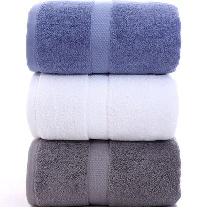 Three cotton bath towels stacked in cornflower, white, and slate — Holm & Hearth