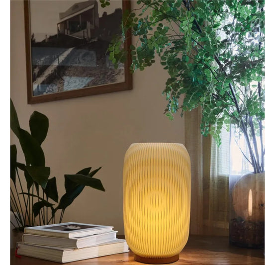 Pleat cordless table lamp glowing warmly on a living room side table — Holm & Hearth