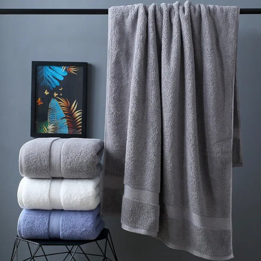 Slate cotton bath towel hanging on rail with stack of three colour options — Holm & Hearth