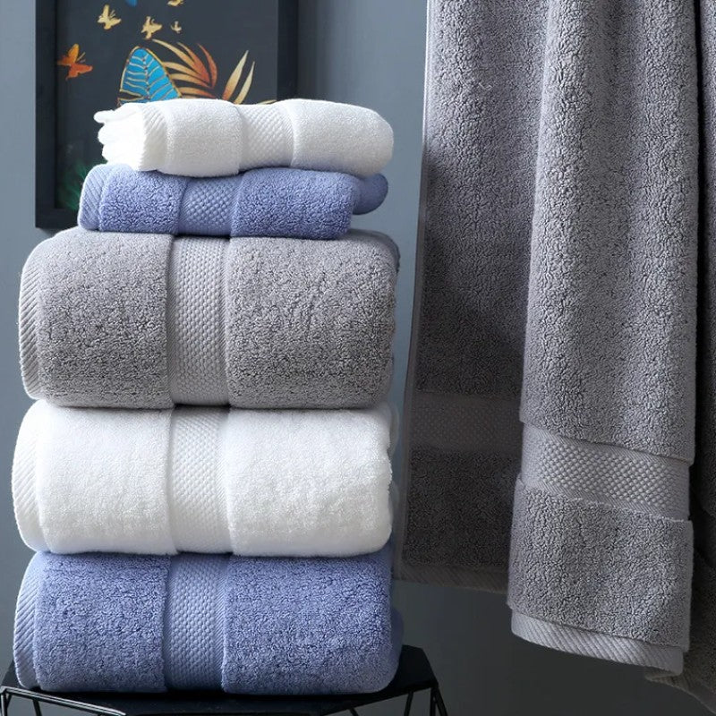 Stack of folded cotton bath towels showing slate, white, and mist blue palette — Holm & Hearth