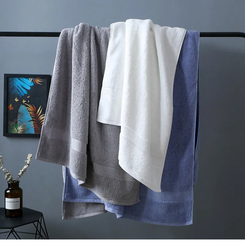 Three cotton bath towels hanging together in slate, white, and mist blue — Holm & Hearth