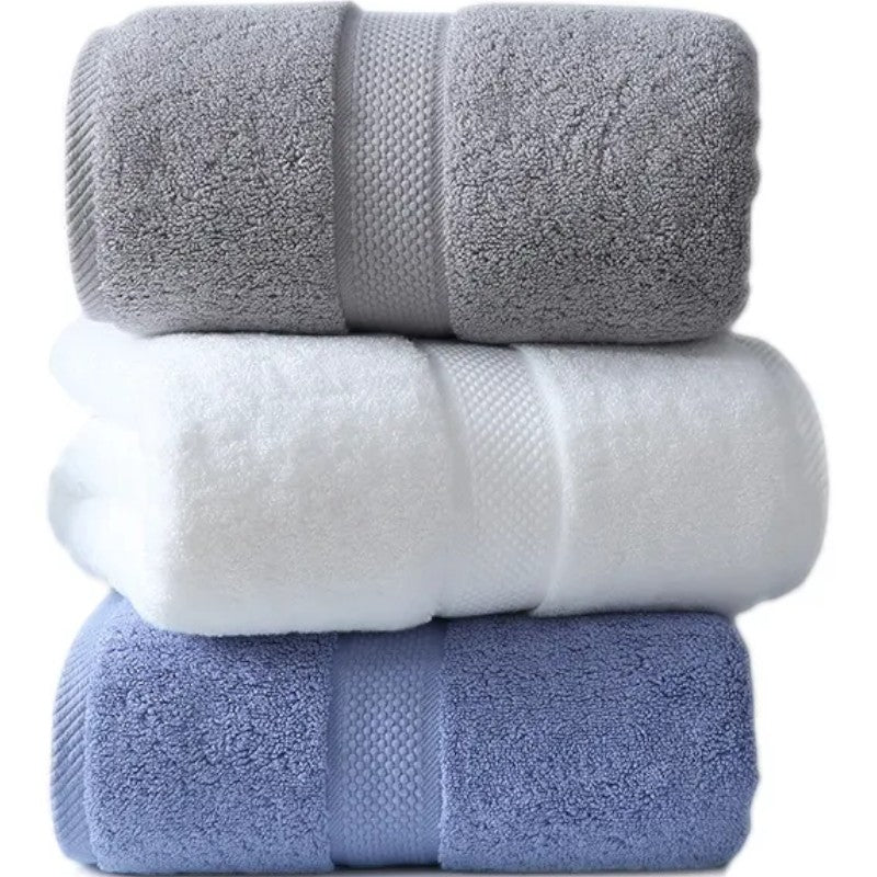 Three rolled cotton bath towels in slate, white, and mist blue — Holm & Hearth