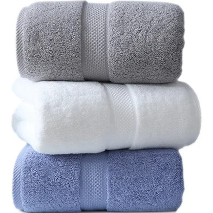 Three rolled cotton bath towels in slate, white, and mist blue — Holm & Hearth