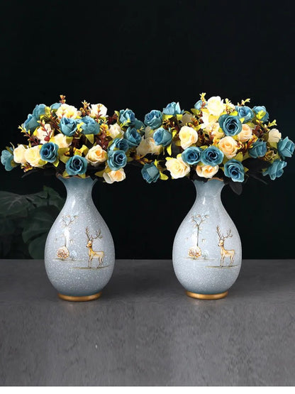 Pair of pale ceramic vases with deer motif holding rose bouquets — Holm & Hearth