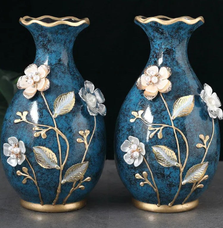 Pair of teal ceramic vases showing raised floral detail close-up — Holm & Hearth