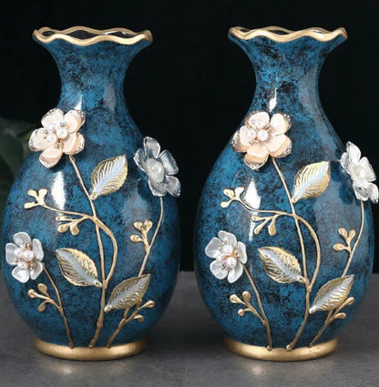 Pair of teal ceramic vases showing raised floral detail close-up — Holm & Hearth