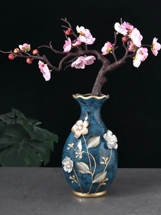 Teal ceramic vase with raised floral detail and plum blossom branch — Holm & Hearth