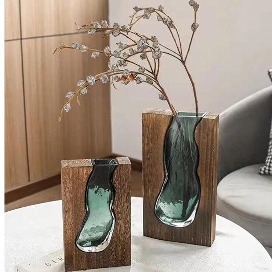 Two wood-framed glass vases with seedhead branch on side table — Holm & Hearth