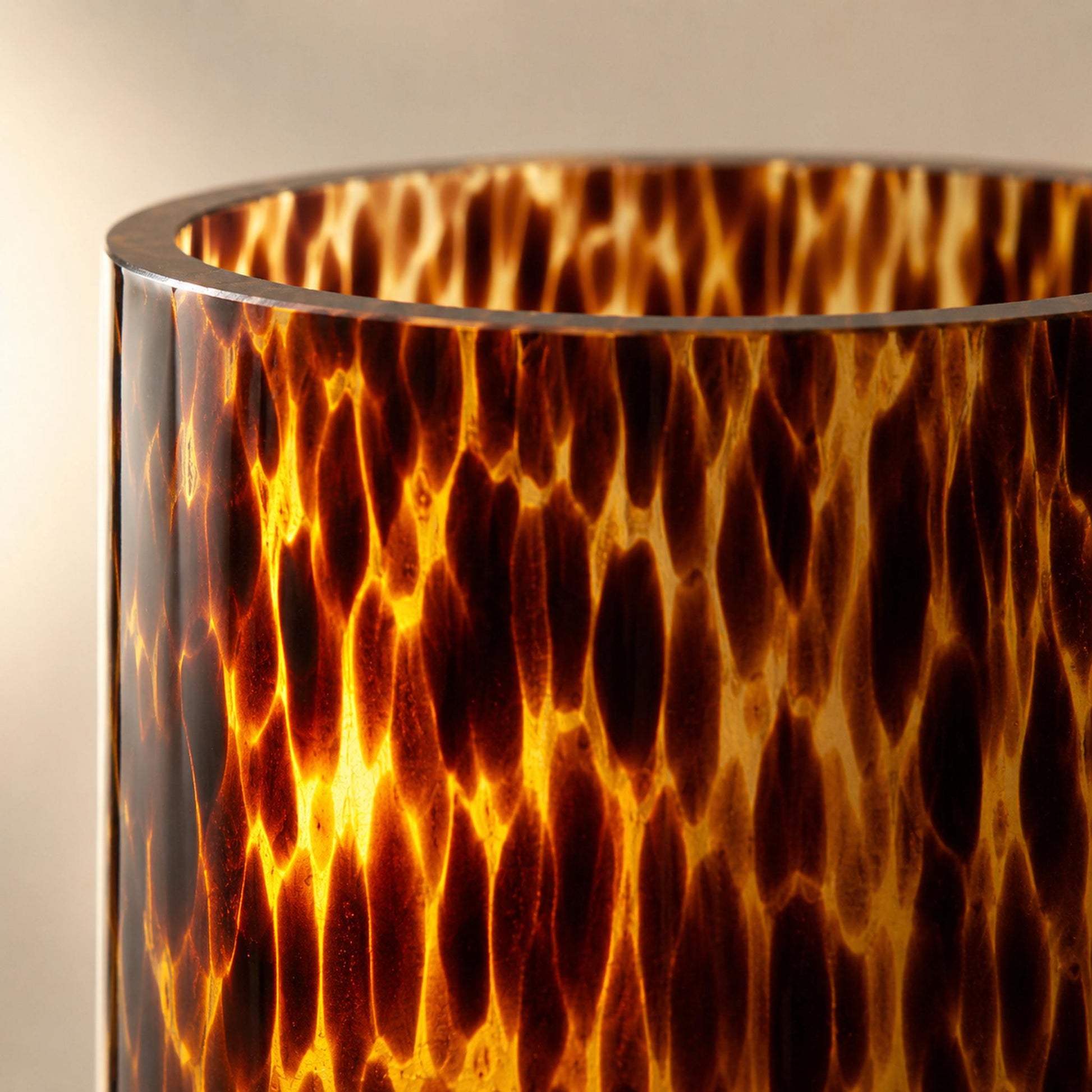 Leopard print glass vase pattern close-up detail with translucent backlit amber tortoiseshell