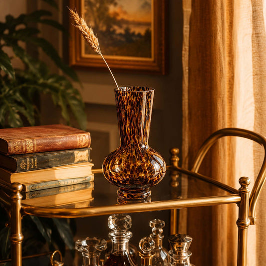 Leopard print glass tapered neck vase styled on brass bar cart with dried wheat