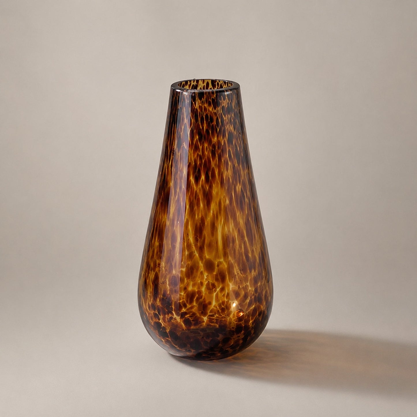 Leopard print glass water drop vase catalogue shot in warm amber tortoiseshell